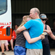 People embrace at the Numeralla Rural Fire Brigade near the scene of a water bomber plane crash on January 23, 2020 in Cooma, Australia.